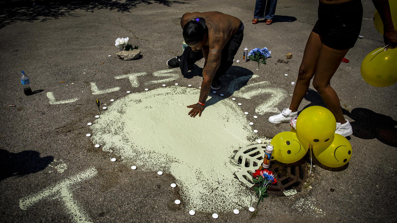 In Chicago, Rickey Turner presses his hand in paint that his family used to cover the blood of his brother, Tony Haywood, on July 18, in the parking lot where Haywood was shot and killed the night before. The Chicago Tribune’s Brian Cassella has been writing a series called “Second Take,” meant to show what happens the day after gun violence hits another piece of Chicago. Sometimes, he said, “people get to know their neighbors a little better.” (Brian Cassella/Chicago Tribune)